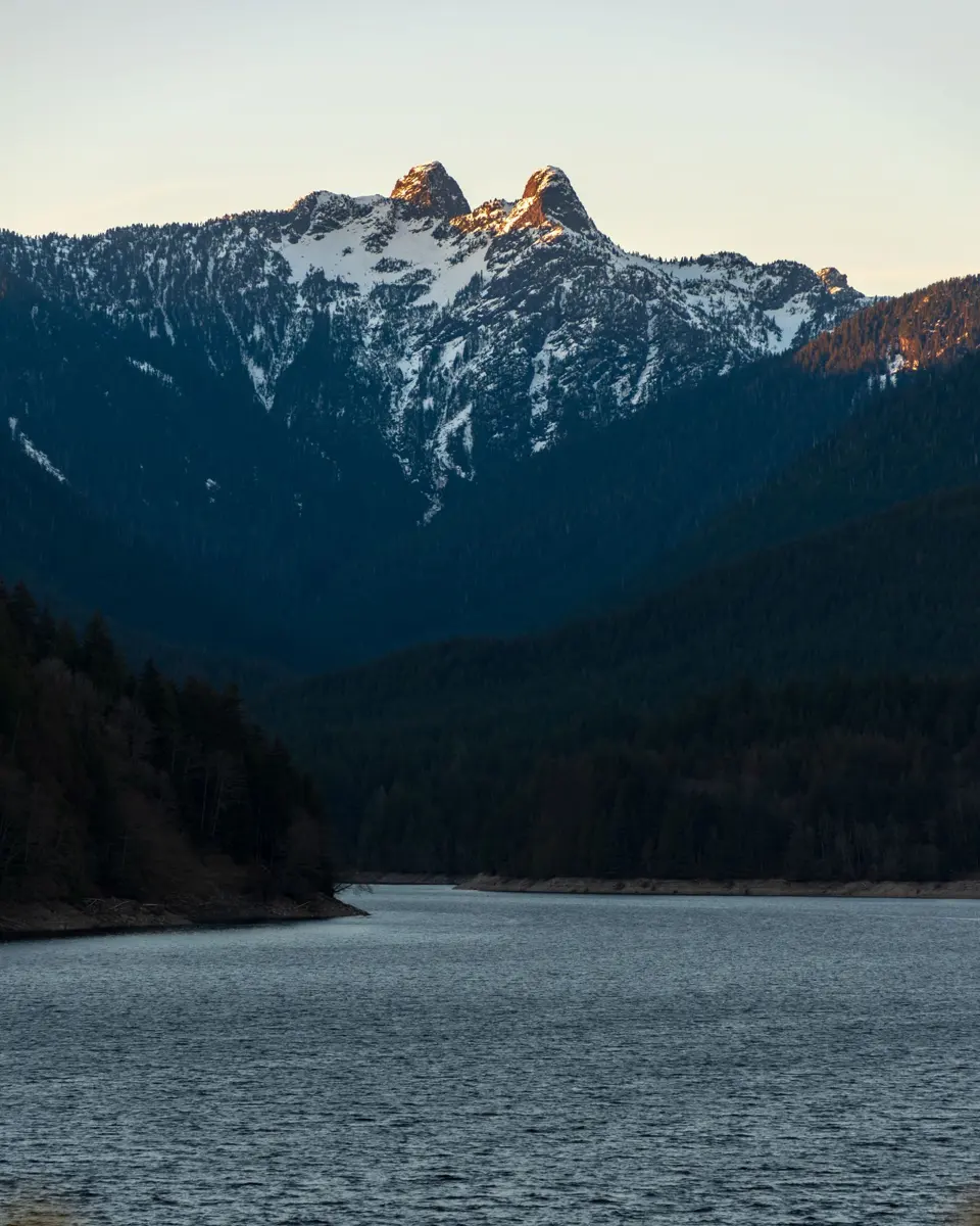 The Lions peaks above Capilano Lake in North Vancouver at sunset